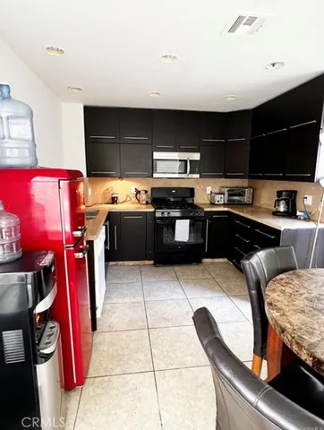 a kitchen with stainless steel appliances granite countertop a sink and a stove