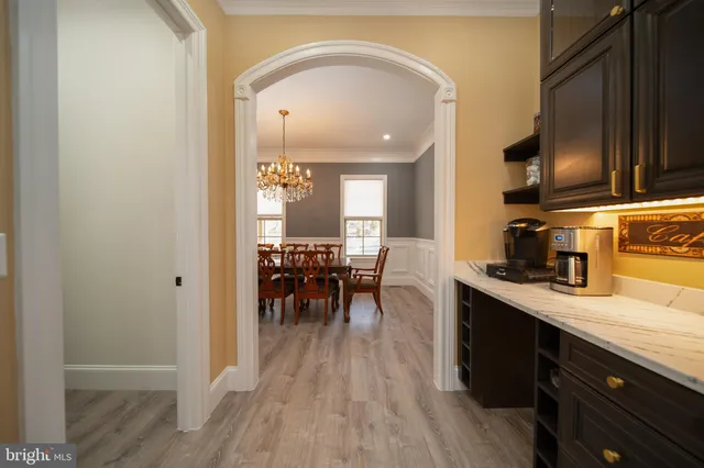 a kitchen with sink cabinets and wooden floor