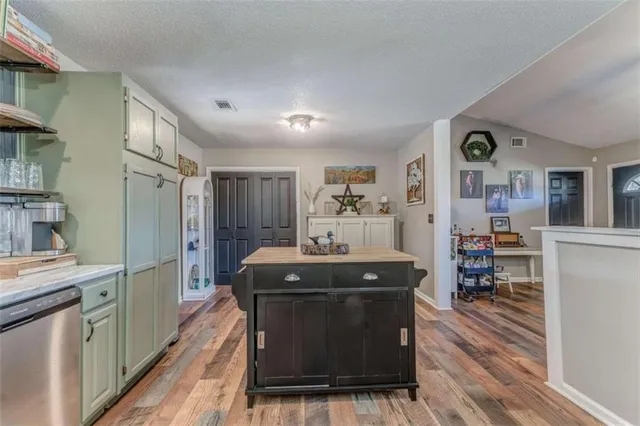 a kitchen with stainless steel appliances granite countertop a stove and a refrigerator
