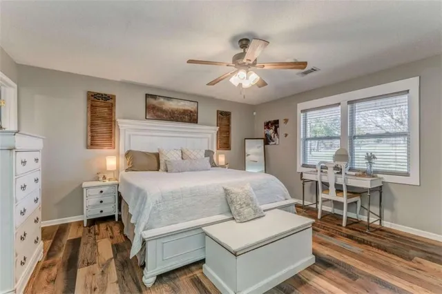 a spacious bedroom with a bed furniture and a window