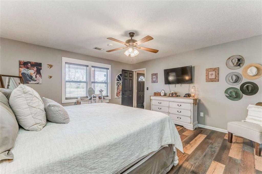 943 Shiloh Road Cedartown, GA 30125 - Photo 23 of 51 a spacious bedroom with a bed and a flat screen tv
