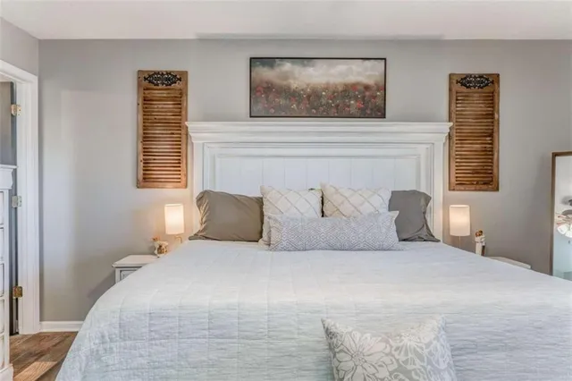 a bedroom with a large bed and a window