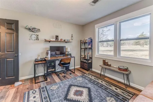 a workspace with furniture window and wooden floor