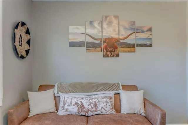 a living room with couch and a mirror