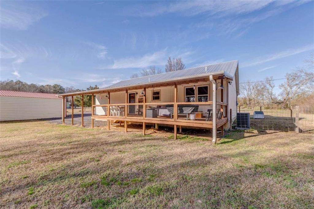 943 Shiloh Road Cedartown, GA 30125 - Photo 41 of 51 a view of a house with a backyard and a large tree
