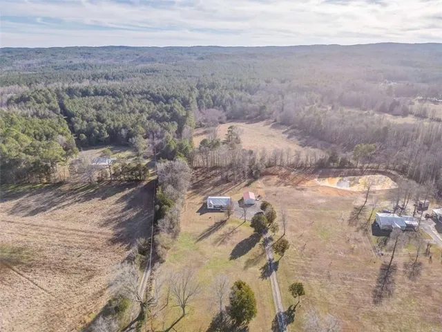a view of a dry yard with wooden fence