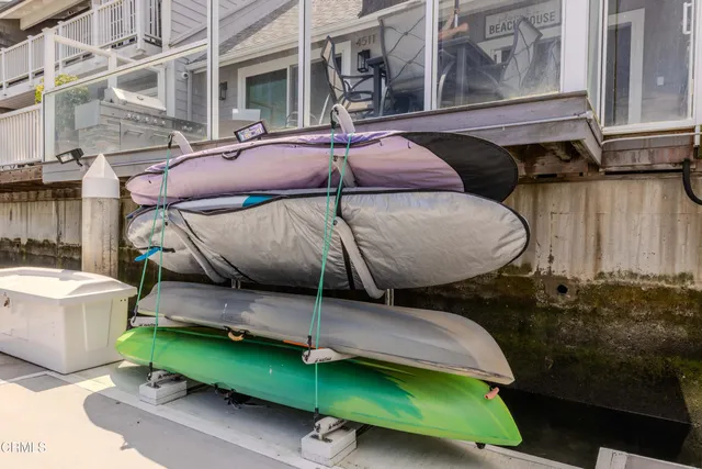 a view of a patio with table and chairs with wooden fence
