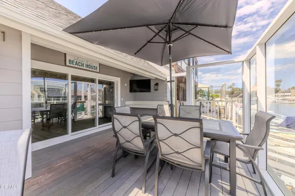 a view of a patio with table and chairs under an umbrella