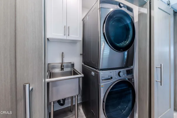 a utility room with sink dryer and washer