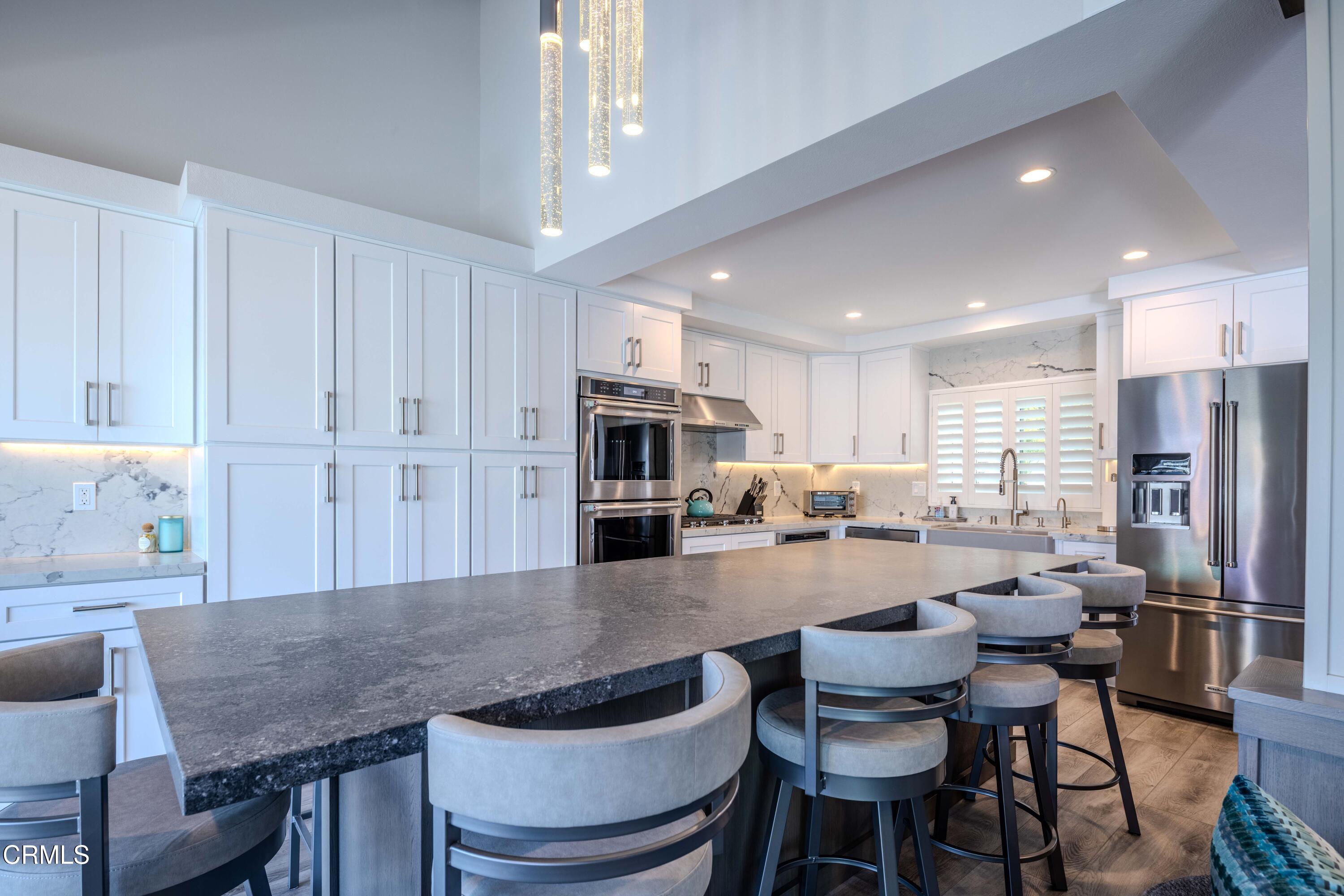 4511 Gateshead Bay Oxnard, CA 93035 - Photo 3 of 36 a large kitchen with a table and chairs