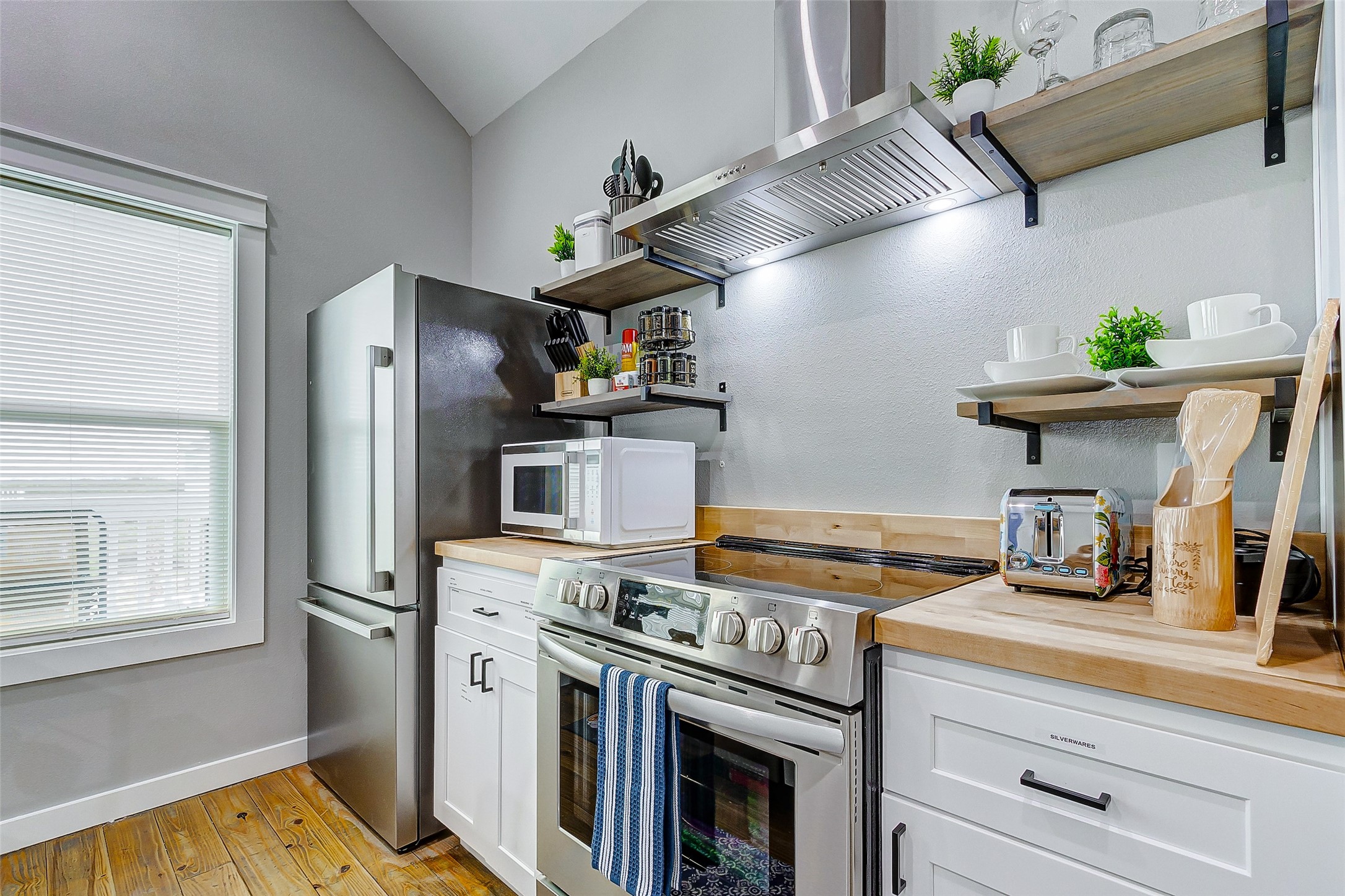 1079 Johnson Road Port Bolivar, TX 77650 - Photo 12 of 35 a kitchen with stainless steel appliances granite countertop a refrigerator and a stove