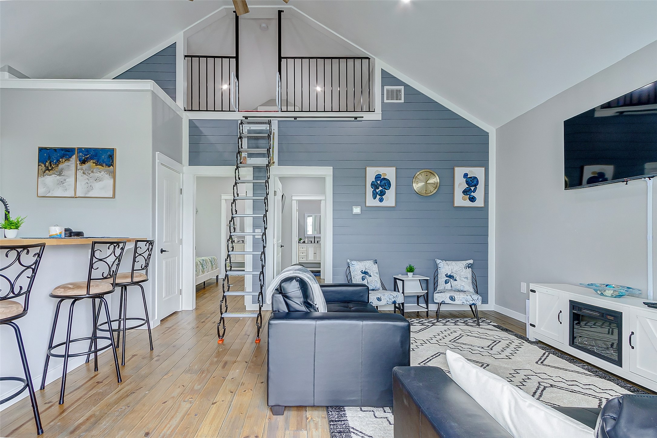 1079 Johnson Road Port Bolivar, TX 77650 - Photo 8 of 35 a living room with furniture a flat screen tv and floor to ceiling window
