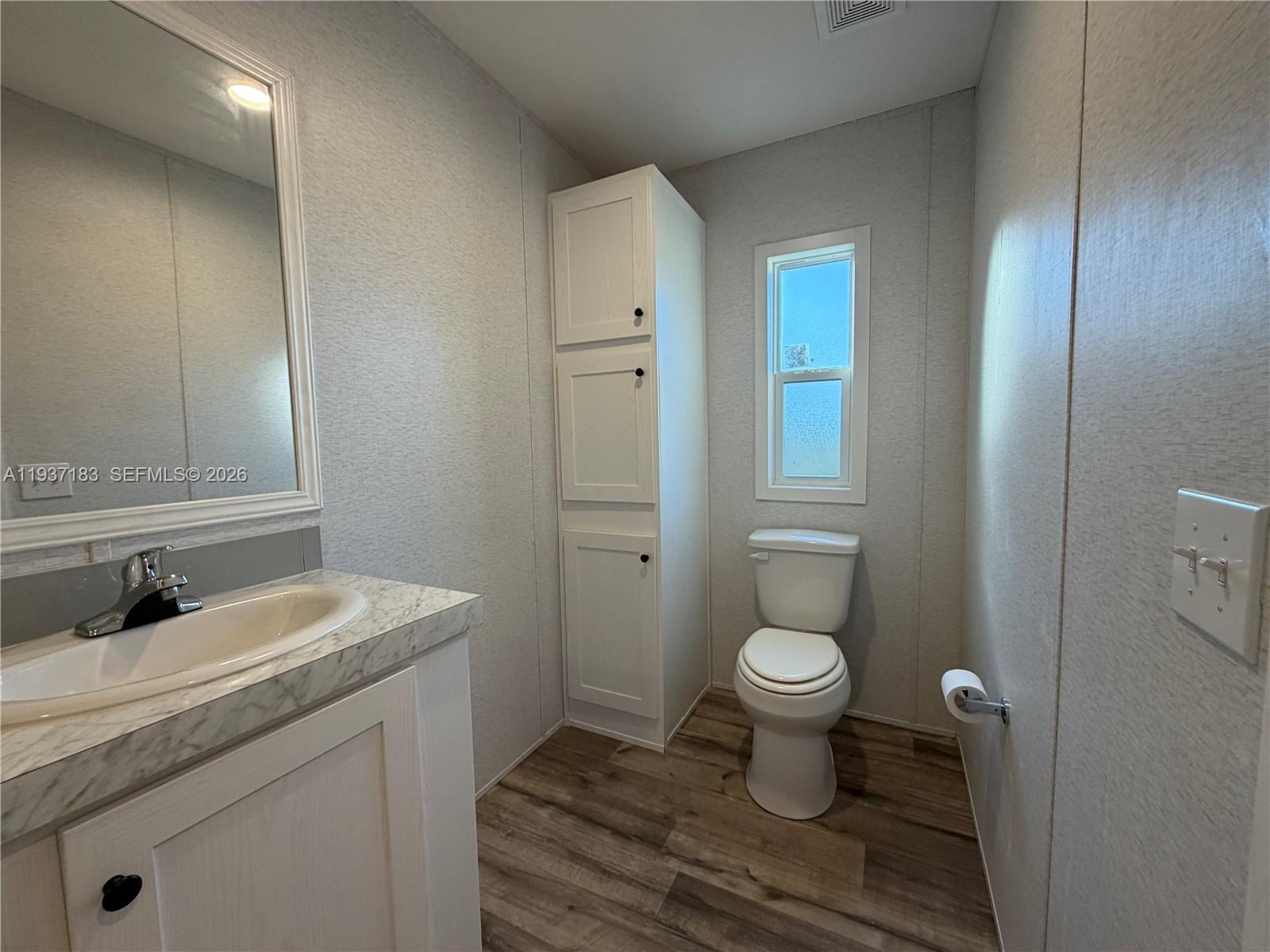 130 North Granja Street Clewiston, FL 33440 - Photo 6 of 10 a bathroom with a sink toilet and a mirror