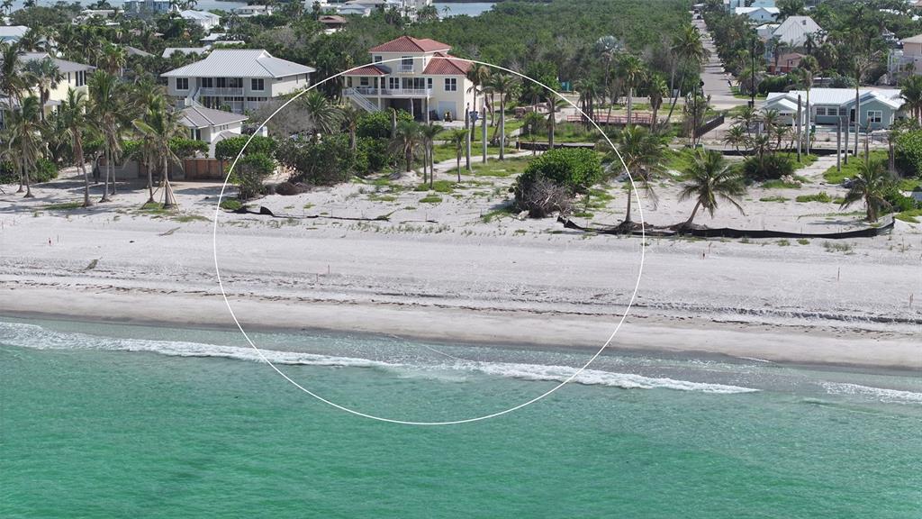 6453 Gulfside Road Longboat Key, FL 34228 - Photo 12 of 21 a front view of a house with a yard and garage