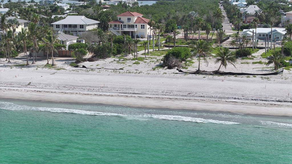 6453 Gulfside Road Longboat Key, FL 34228 - Photo 13 of 21 a front view of a house with a yard and lake view
