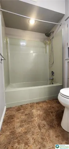 a bathroom with a shower and a toilet