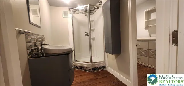a view of a bathroom with tub and shower