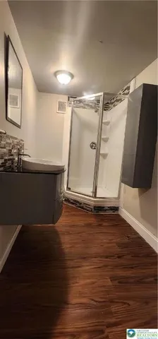 a room with wooden floor and window