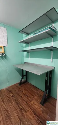 a room with a bed and a dresser