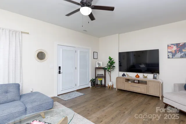 a living room with furniture and wooden floor