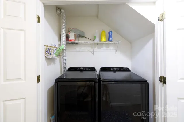 a bedroom with bed and a chandelier