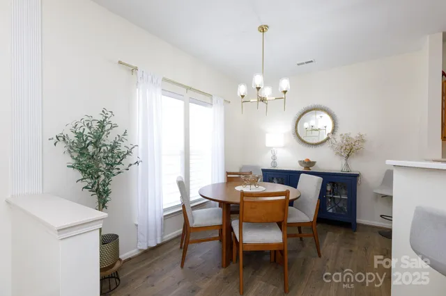 a dining room with furniture and wooden floor
