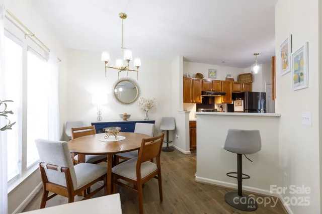 a kitchen with stainless steel appliances granite countertop a refrigerator a stove and a sink with cabinets