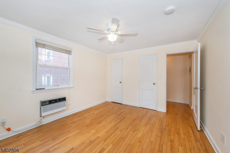 445 Morris Avenue, Unit 7 Springfield, NJ 07081 - Photo 11 of 16 a view of empty room with wooden floor and fan