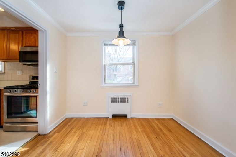445 Morris Avenue, Unit 7 Springfield, NJ 07081 - Photo 5 of 16 a view of a room with wooden floor electronic appliances and window