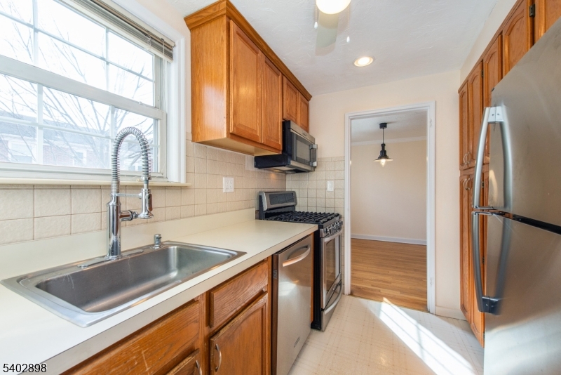 445 Morris Avenue, Unit 7 Springfield, NJ 07081 - Photo 9 of 16 a kitchen with stainless steel appliances granite countertop a refrigerator a sink and a stove