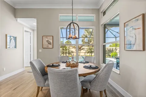 a living room with furniture a large window with wooden floor
