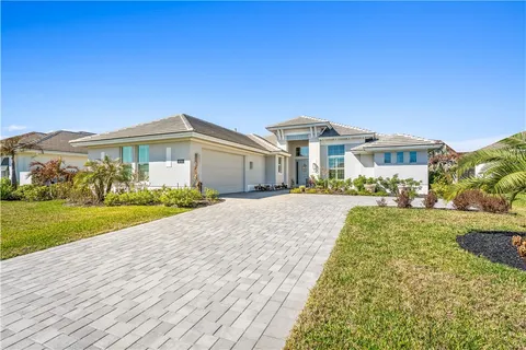 a front view of a house with a garden and yard