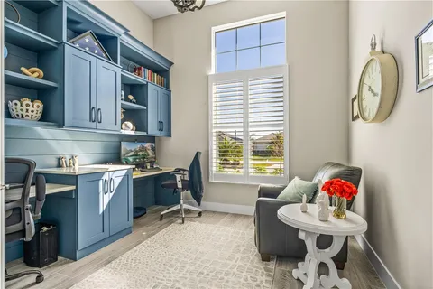 a view of a livingroom with workspace and a window