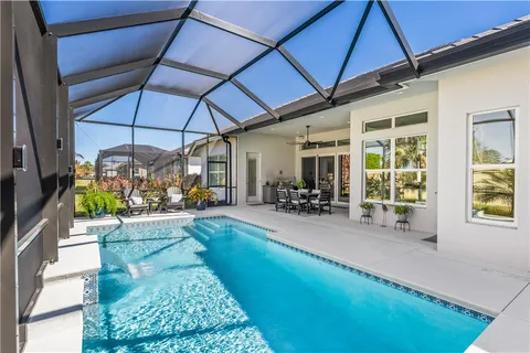a view of a house with backyard porch and sitting area