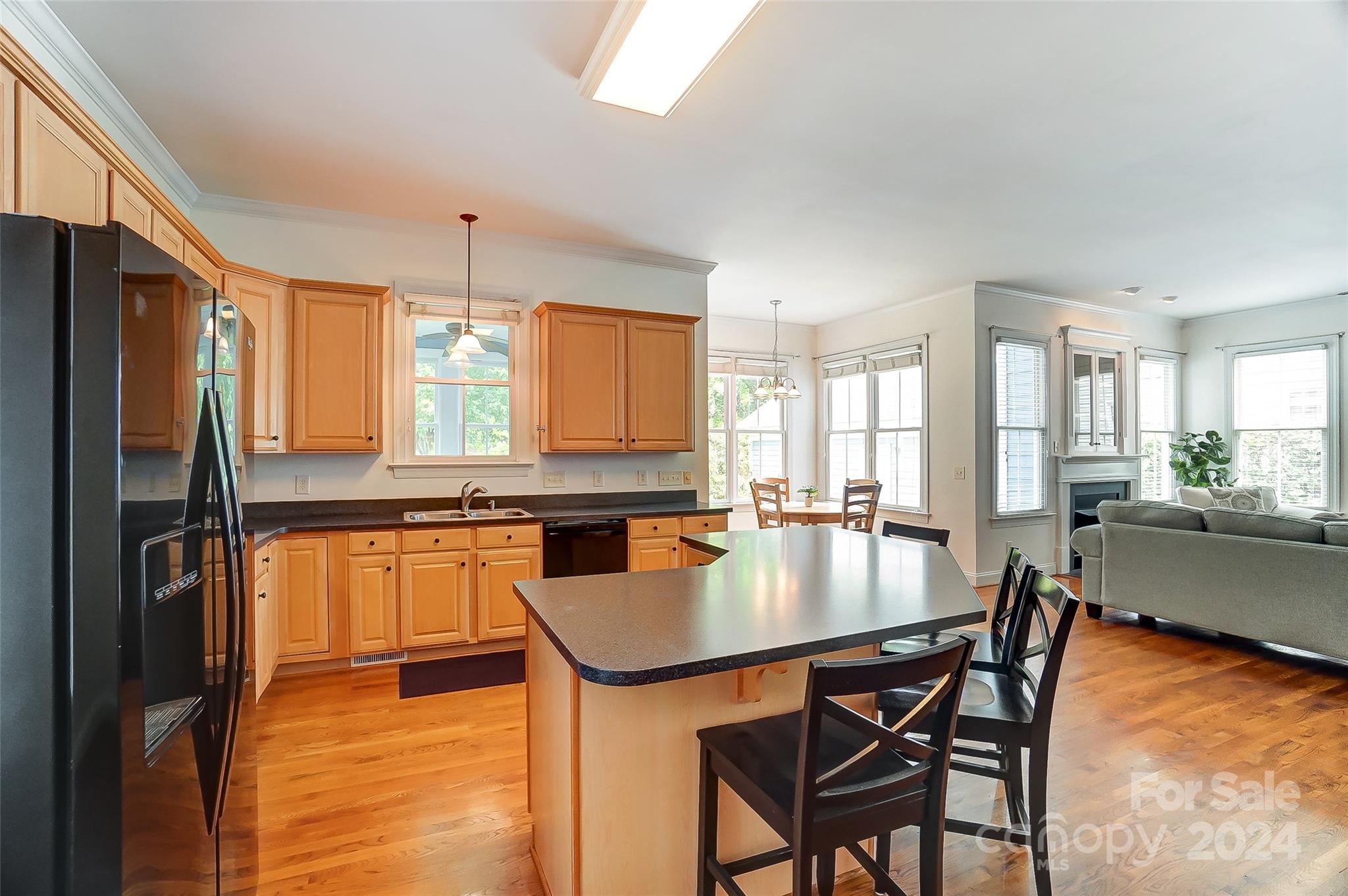 412 Sophia Court Fort Mill, SC 29708 - Photo 11 of 34 a kitchen with stainless steel appliances granite countertop a stove a refrigerator a kitchen island a table and chairs in it