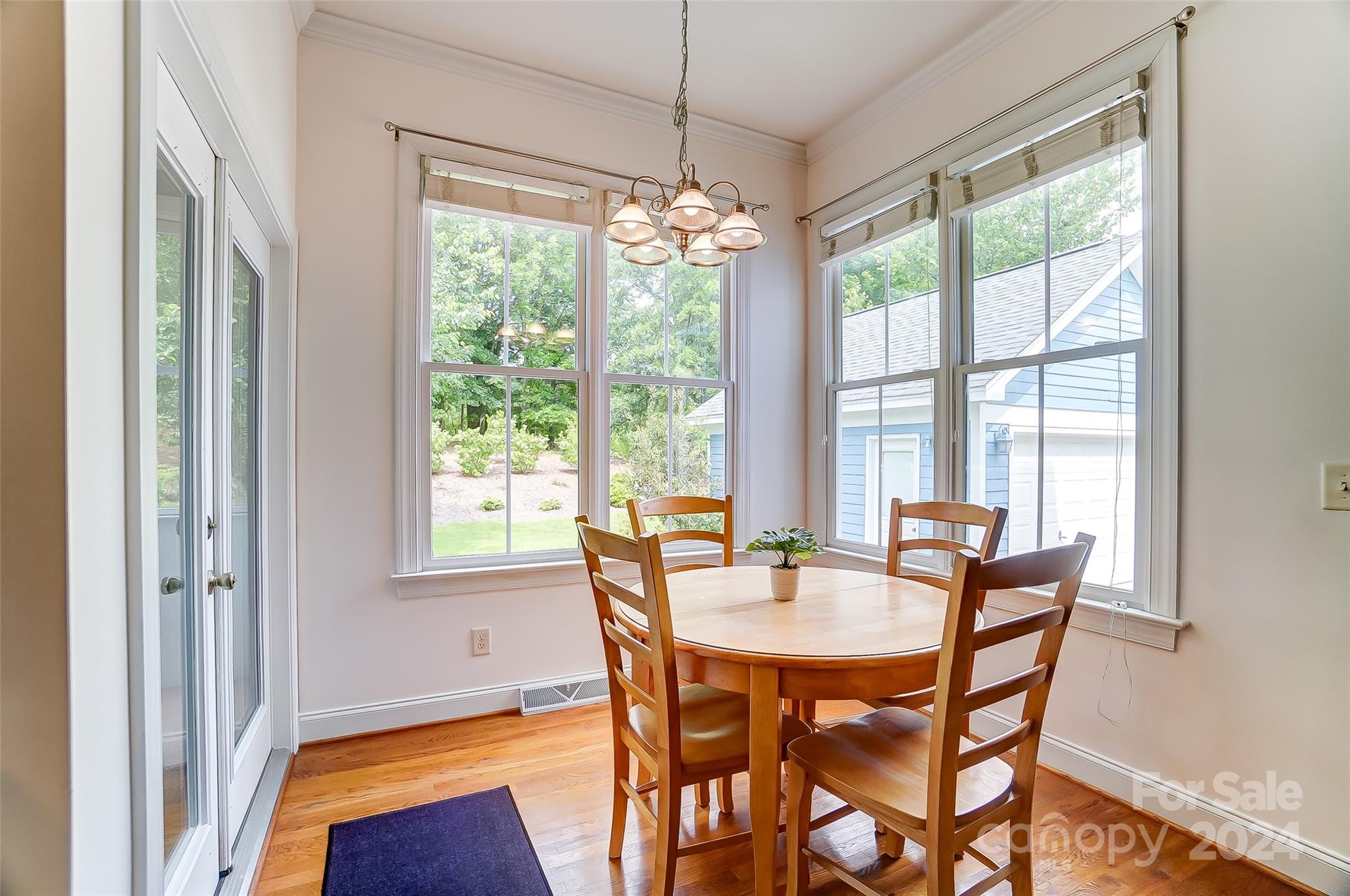 412 Sophia Court Fort Mill, SC 29708 - Photo 12 of 34 a dining room with furniture a chandelier and wooden floor
