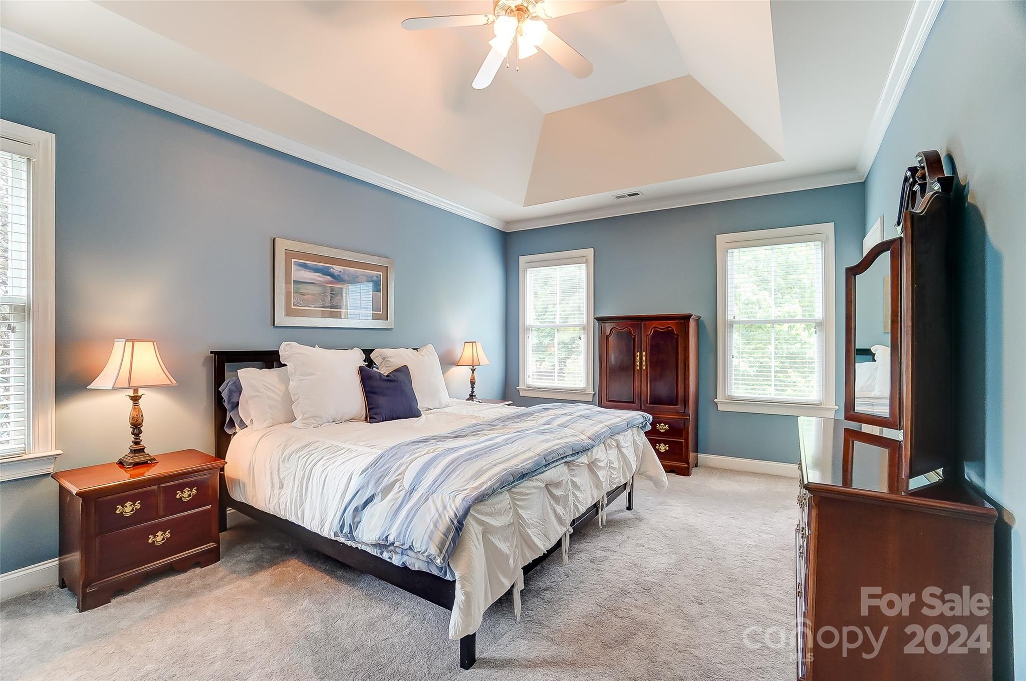 412 Sophia Court Fort Mill, SC 29708 - Photo 16 of 34 a bedroom with a bed and a flat tv screen on dresser