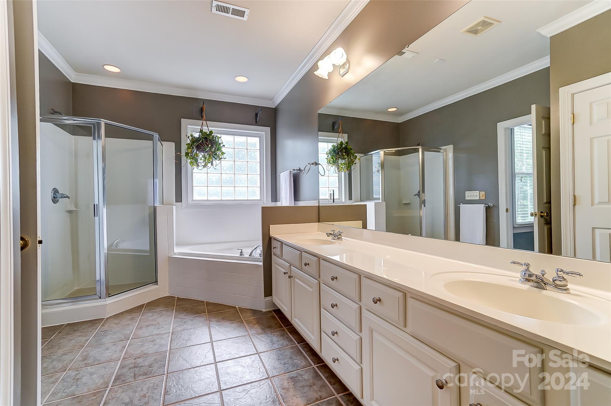 412 Sophia Court Fort Mill, SC 29708 - Photo 18 of 34 a spacious bathroom with a tub sink shower and mirror