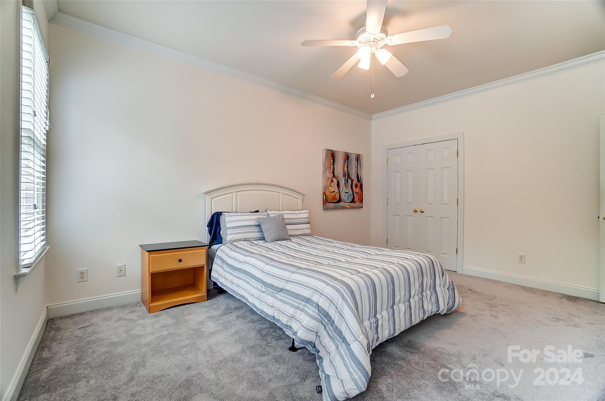 412 Sophia Court Fort Mill, SC 29708 - Photo 20 of 34 a bedroom with a bed and a chandelier