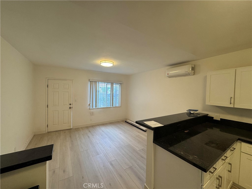 2950 Honolulu Avenue, Unit G Glendale, CA 91214 - Photo 3 of 7 a kitchen with granite countertop a sink and a stove top oven