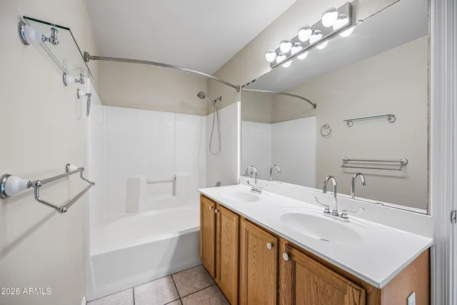 a bathroom with a sink double vanity mirror and a bathtub