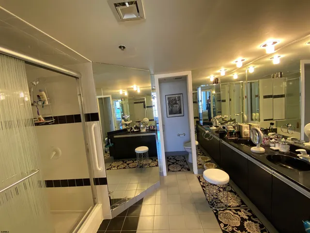 a bathroom with a sink a mirror and a shower