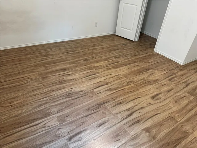 a view of a room with wooden floor
