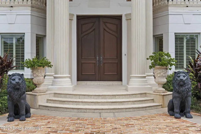 a living room with furniture a fireplace and a chandelier