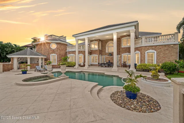 a view of a lake with a table and chairs next to a yard