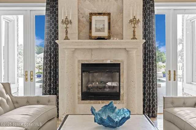 a bedroom with a bed and a large mirror next to a window