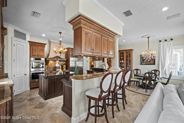 a view of a patio with couches table and chairs potted plants and palm tree