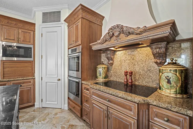 an aerial view of a city with lots of residential buildings ocean and mountain view in back