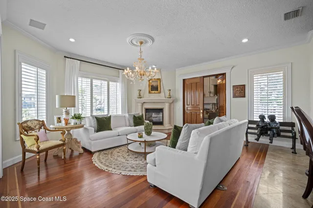 an aerial view of a house with a garden and lake view
