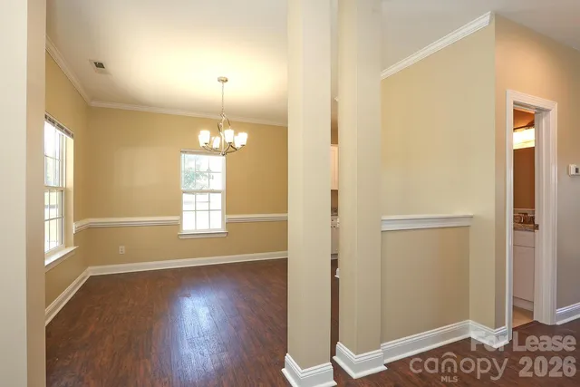 a view of a livingroom with wooden floor and a window